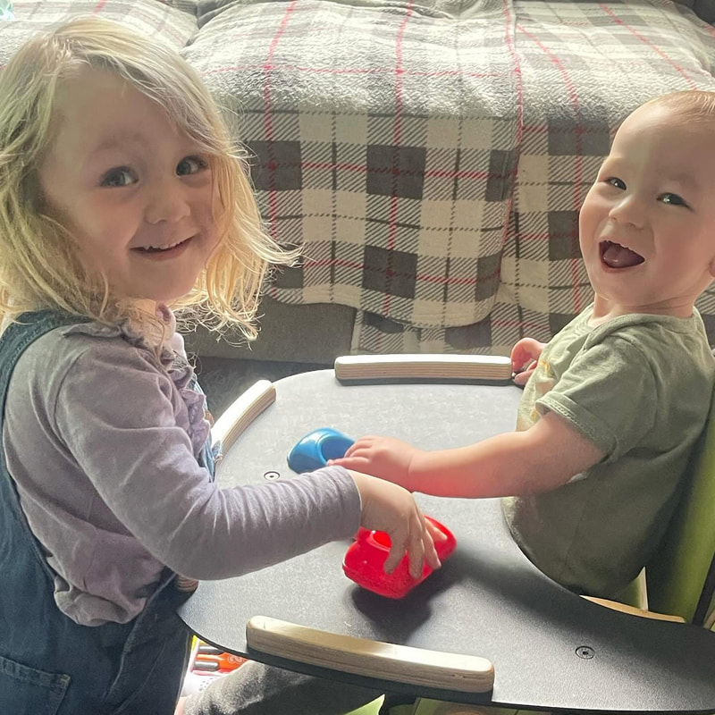 Two children smiling and playing together