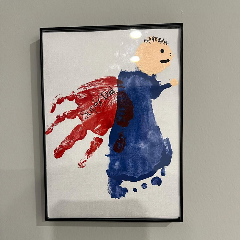 A framed handprint artwork made by a child